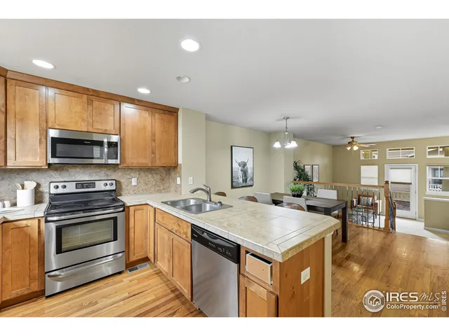 a kitchen with a stove a sink and a refrigerator