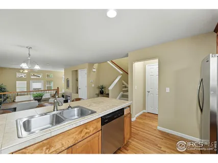 a kitchen with stainless steel appliances granite countertop a sink a stove and a refrigerator