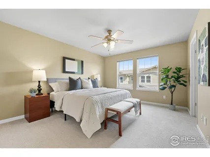 a spacious bedroom with a bed and a potted plant