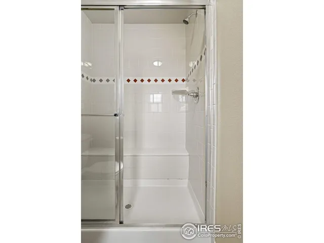 a bathroom with a glass shower door