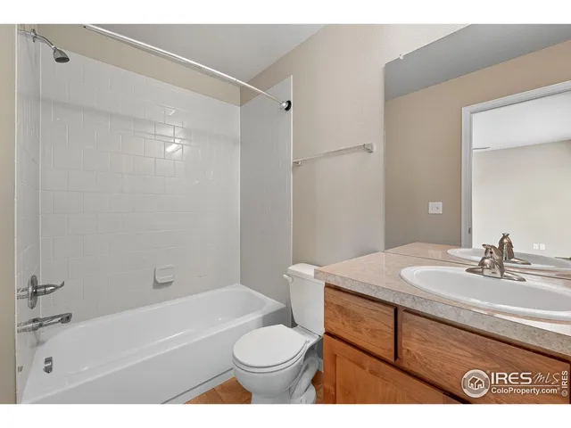a bathroom with a sink toilet vanity and shower