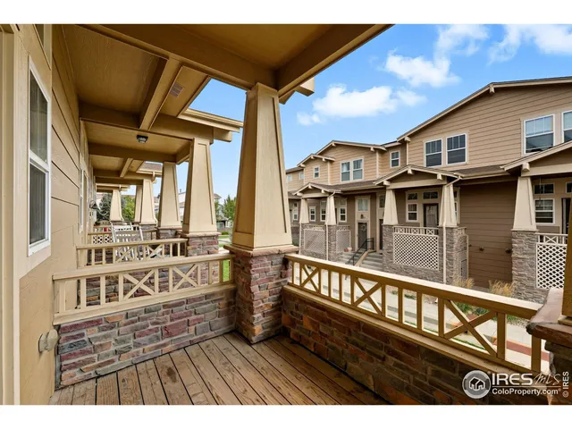 a view of a house with pool and wooden fence