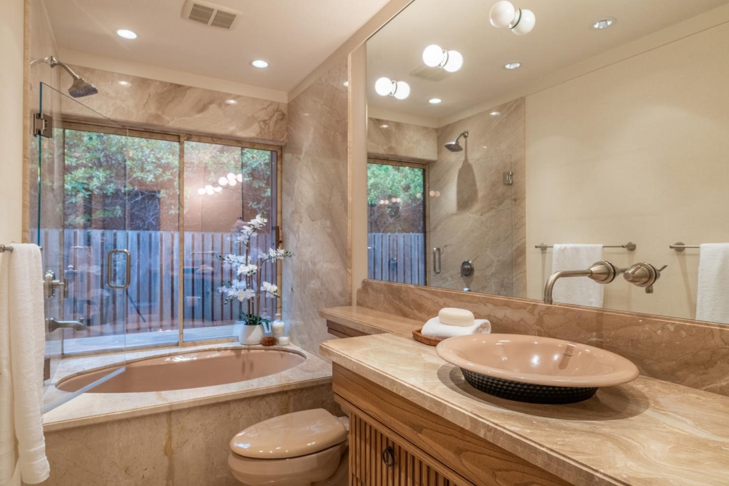 46 Middle Canyon Road Carmel Valley, CA 93924 - Photo 31 of 74 a bathroom with a granite countertop sink and a mirror