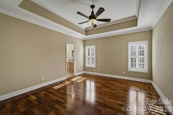 a view of room with wooden floor and ceiling fan