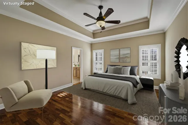 a bedroom with a bed a couch and a ceiling fan