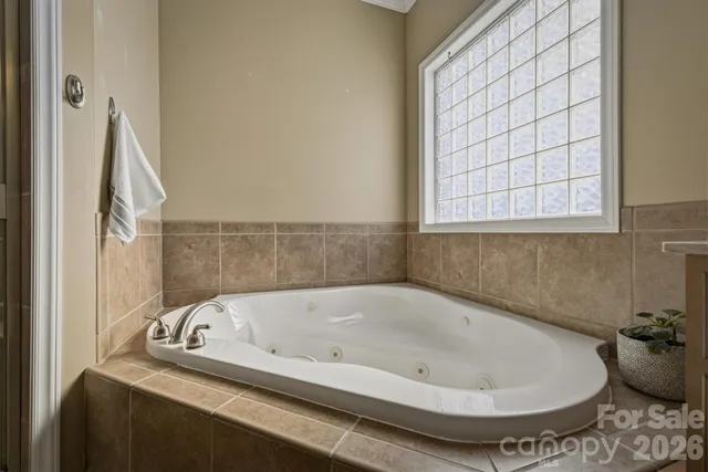 a bath tub sitting in a bathroom next to a window