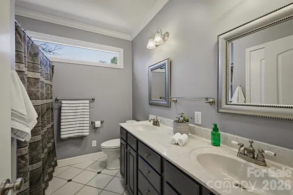 a bathroom with a sink double vanity and a toilet