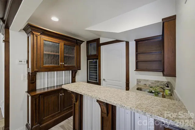 a kitchen with granite countertop cabinets and wooden floor