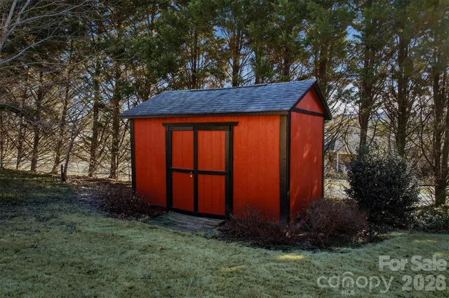 a view of a backyard with large trees