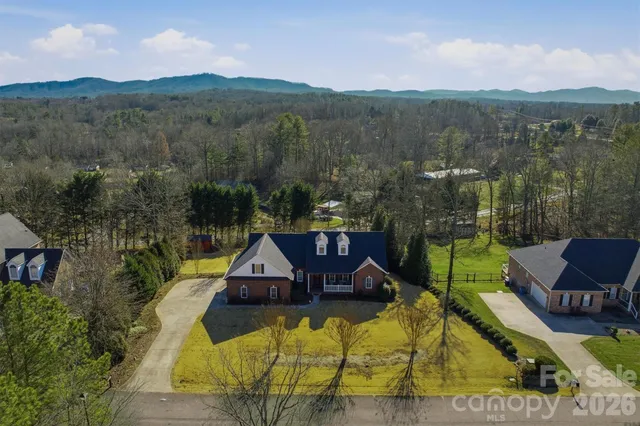 a view of a swimming pool with a yard and mountain view