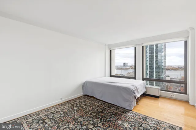 a spacious bedroom with a bed and glass door
