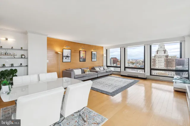 a living room with furniture and large windows