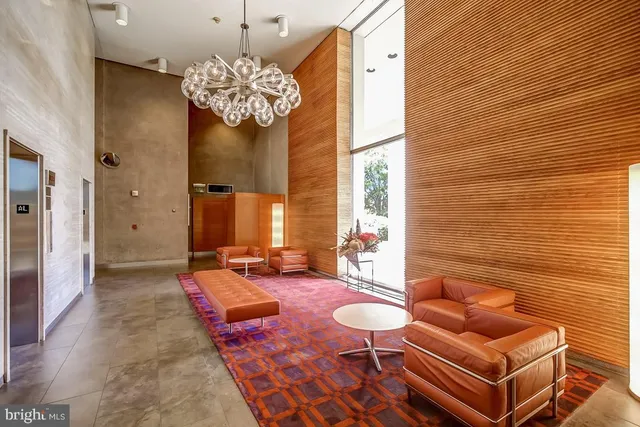 a living room with furniture and a chandelier