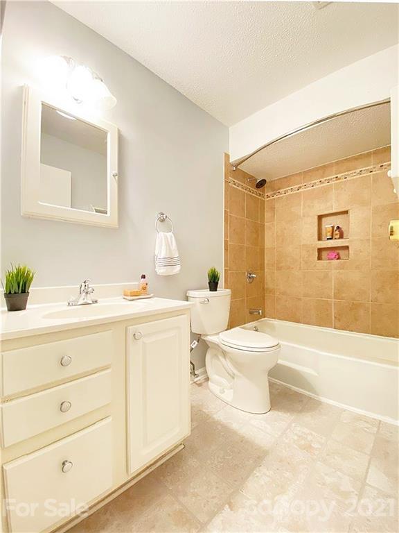 2606 Park Road Charlotte, NC 28209 - Photo 11 of 16 a bathroom with a sink a toilet and shower