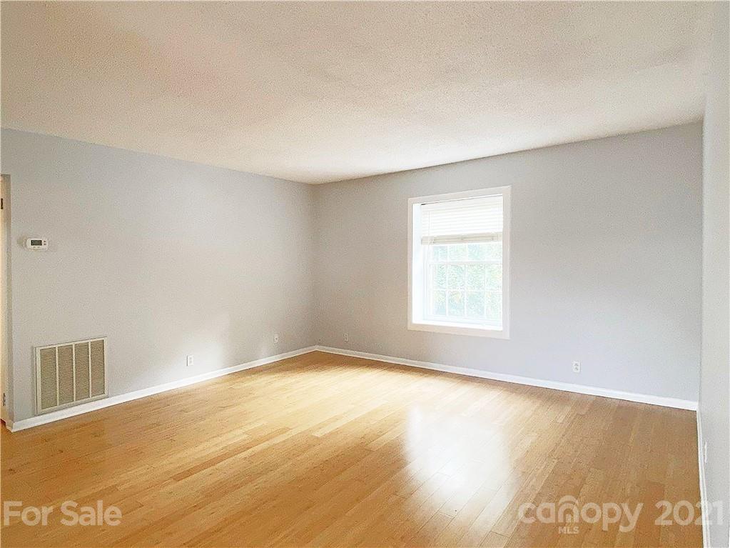 2606 Park Road Charlotte, NC 28209 - Photo 4 of 16 a view of an empty room with wooden floor and a window