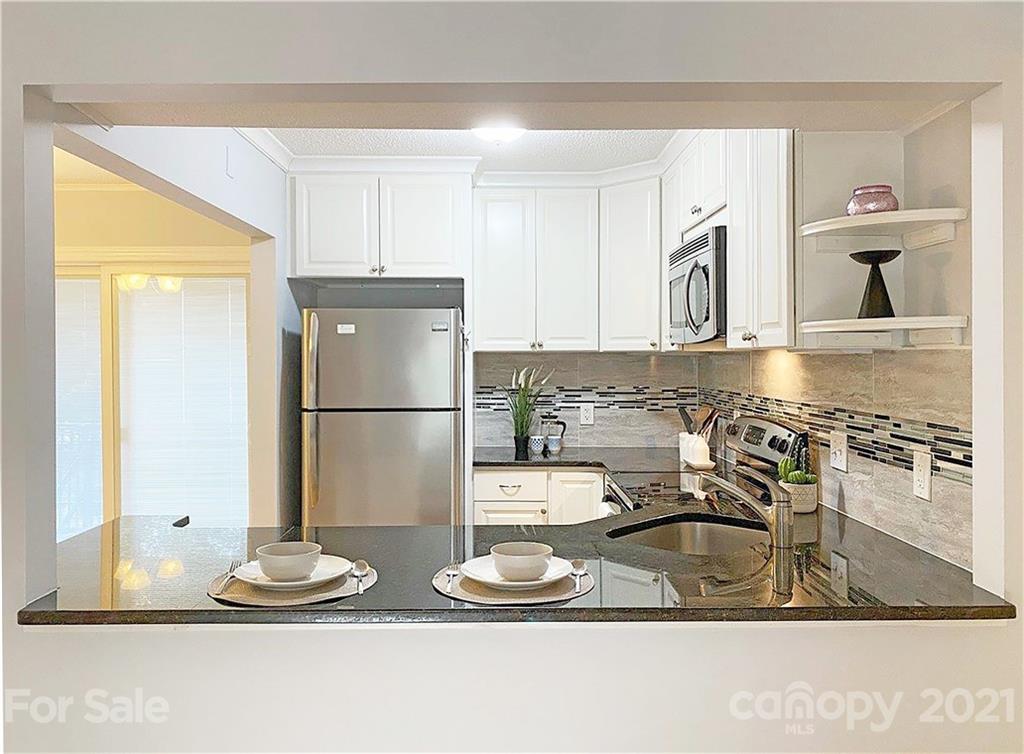 2606 Park Road Charlotte, NC 28209 - Photo 6 of 16 a kitchen with a refrigerator and a sink