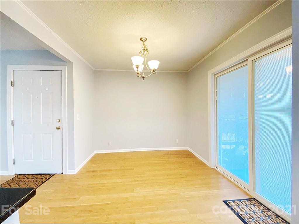 2606 Park Road Charlotte, NC 28209 - Photo 8 of 16 a bedroom with a bed and a chandelier