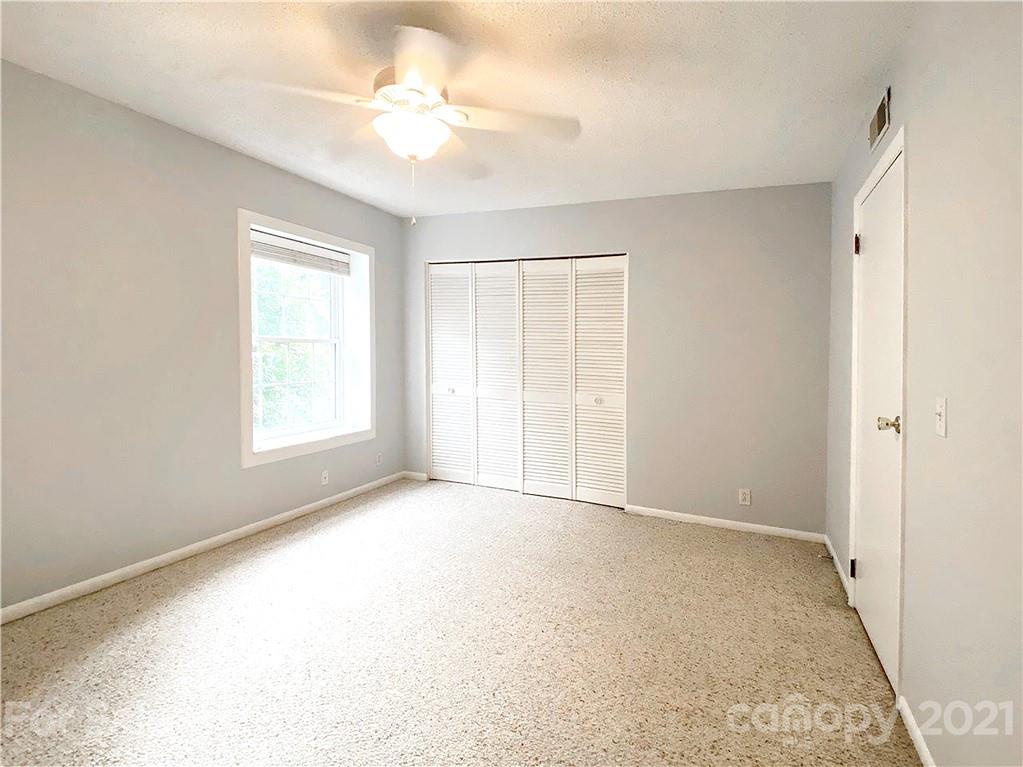 2606 Park Road Charlotte, NC 28209 - Photo 9 of 16 an empty room with windows and fan