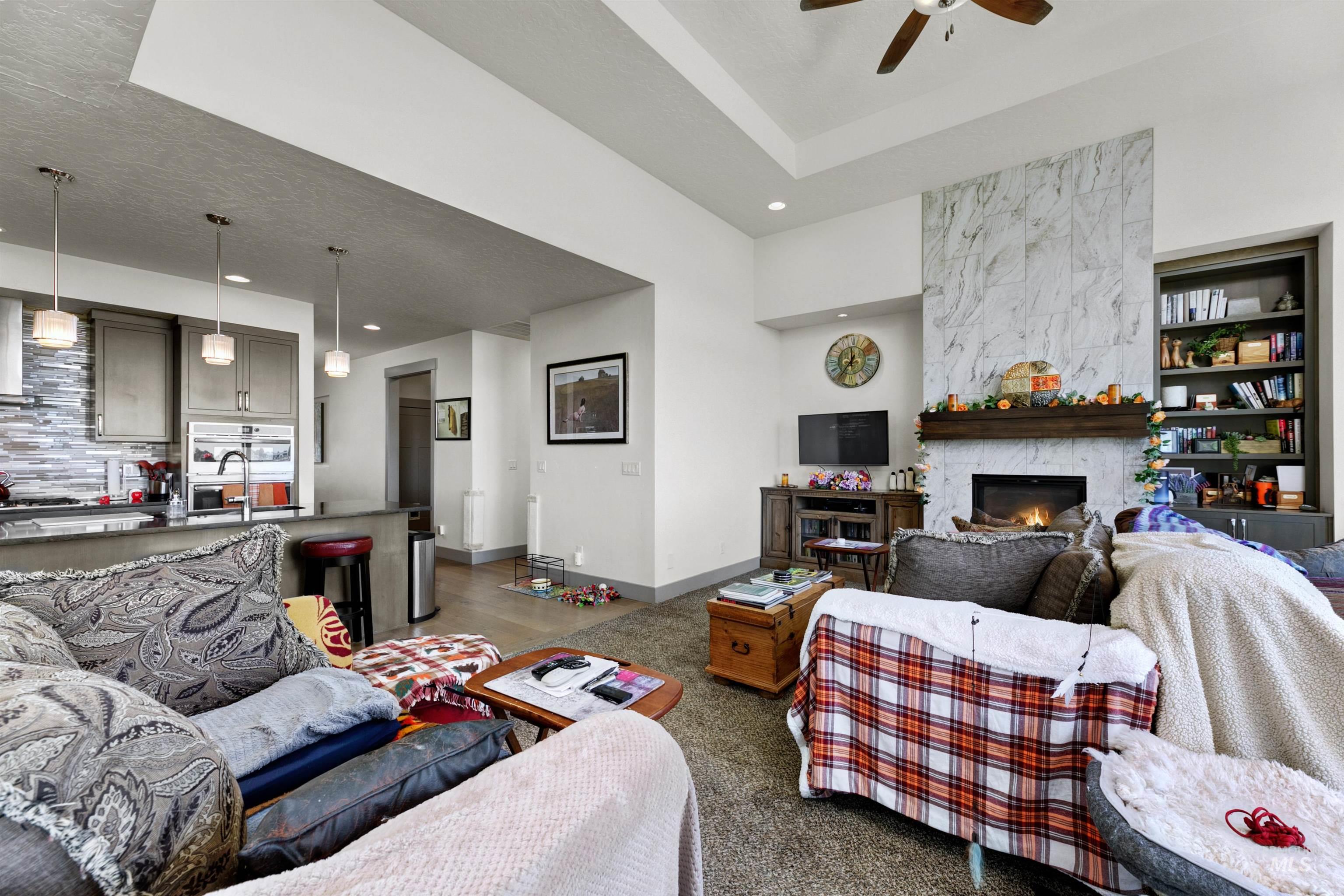 24398 Tombstone Ridge Court Middleton, ID 83644 - Photo 26 of 47 Open-concept living space with a tray ceiling and a ceiling fan