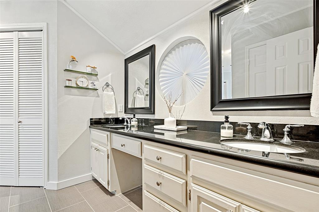 3642 Word Street Dallas, TX 75204 - Photo 23 of 29 a bathroom with double sink and a mirror
