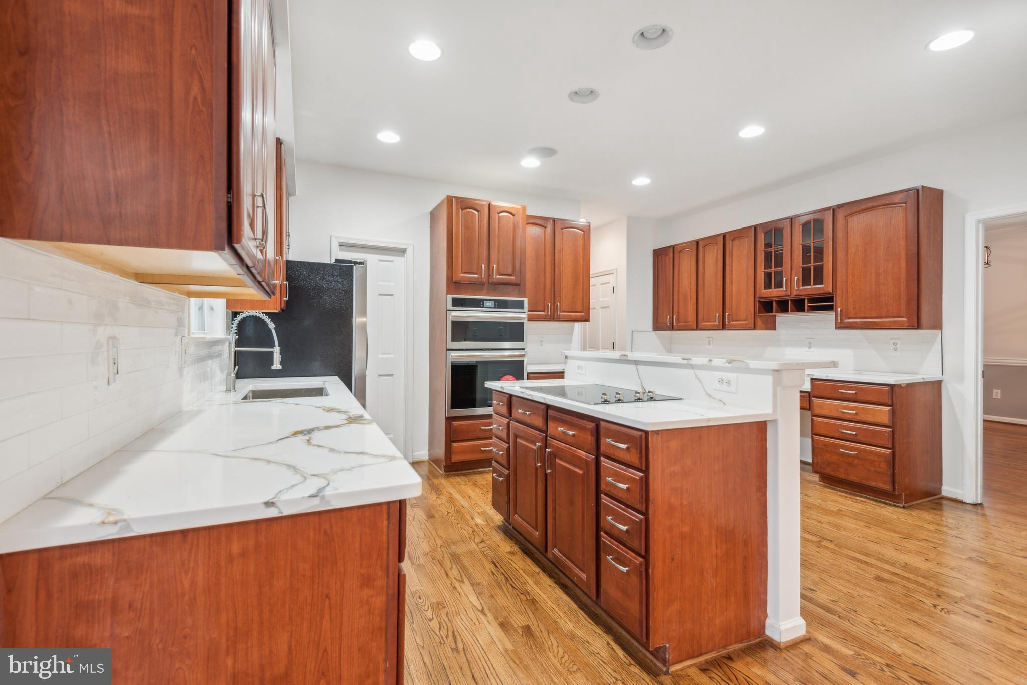 1825 Johnson Road Annapolis, MD 21409 - Photo 12 of 44 a kitchen with stainless steel appliances granite countertop a stove top oven a refrigerator a sink and dishwasher with wooden floor