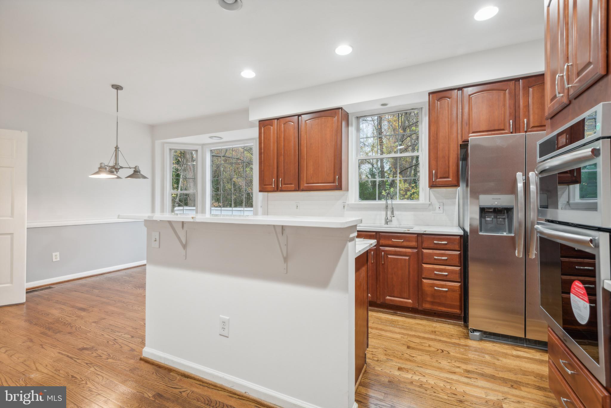1825 Johnson Road Annapolis, MD 21409 - Photo 13 of 44 a kitchen with stainless steel appliances granite countertop a refrigerator sink and cabinets