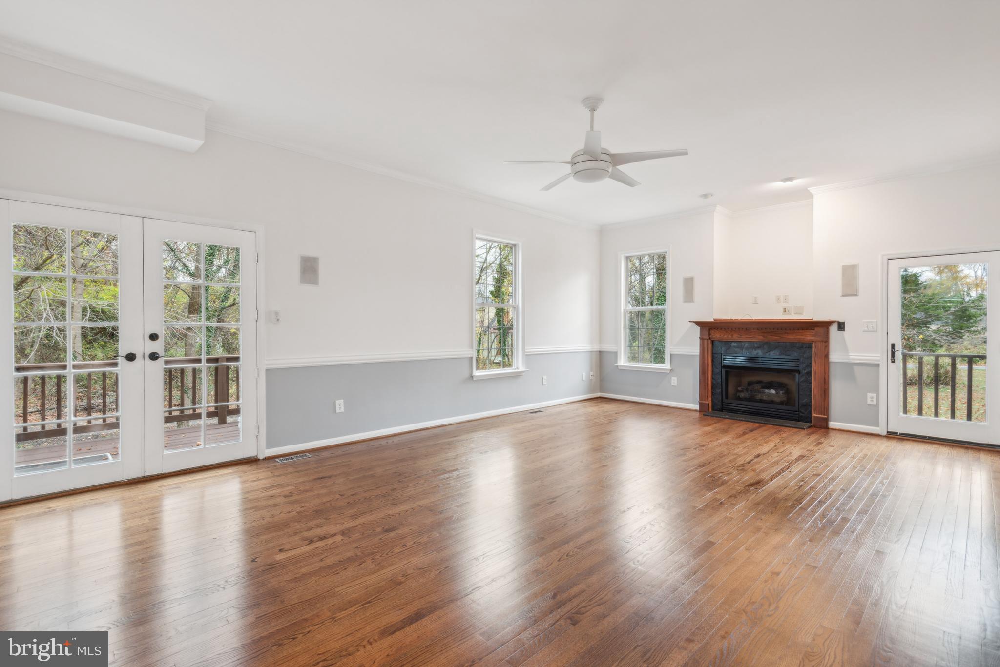 1825 Johnson Road Annapolis, MD 21409 - Photo 8 of 44 an empty room with wooden floor fireplace and windows