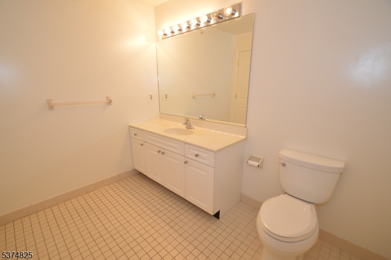 1 Jenny Lind Street, Unit 20 Netcong, NJ 07857 - Photo 12 of 25 a bathroom with a toilet a sink and mirror