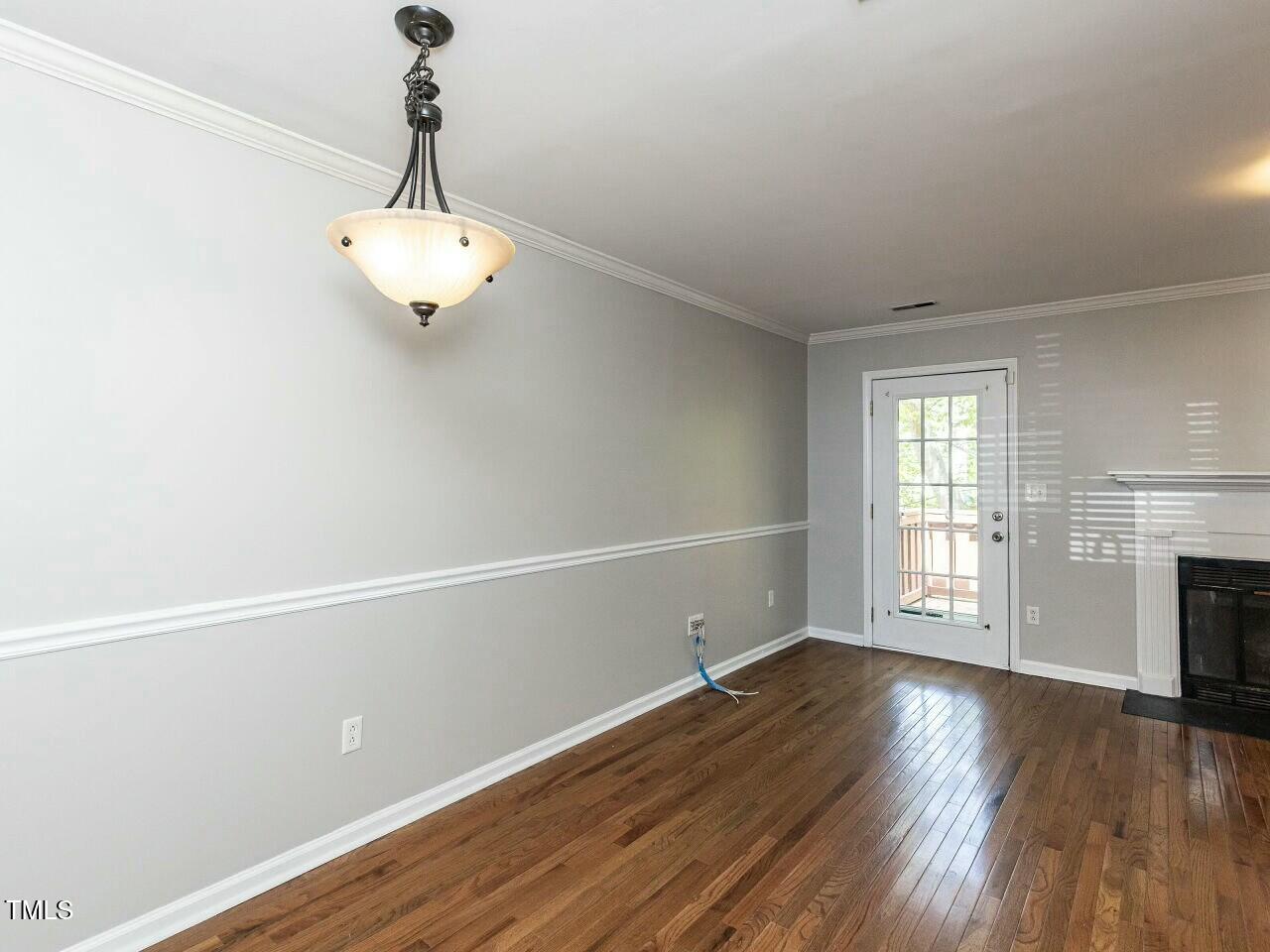 116 Old Maple Lane Durham, NC 27713 - Photo 12 of 30 a view of an empty room with wooden floor fireplace and a window
