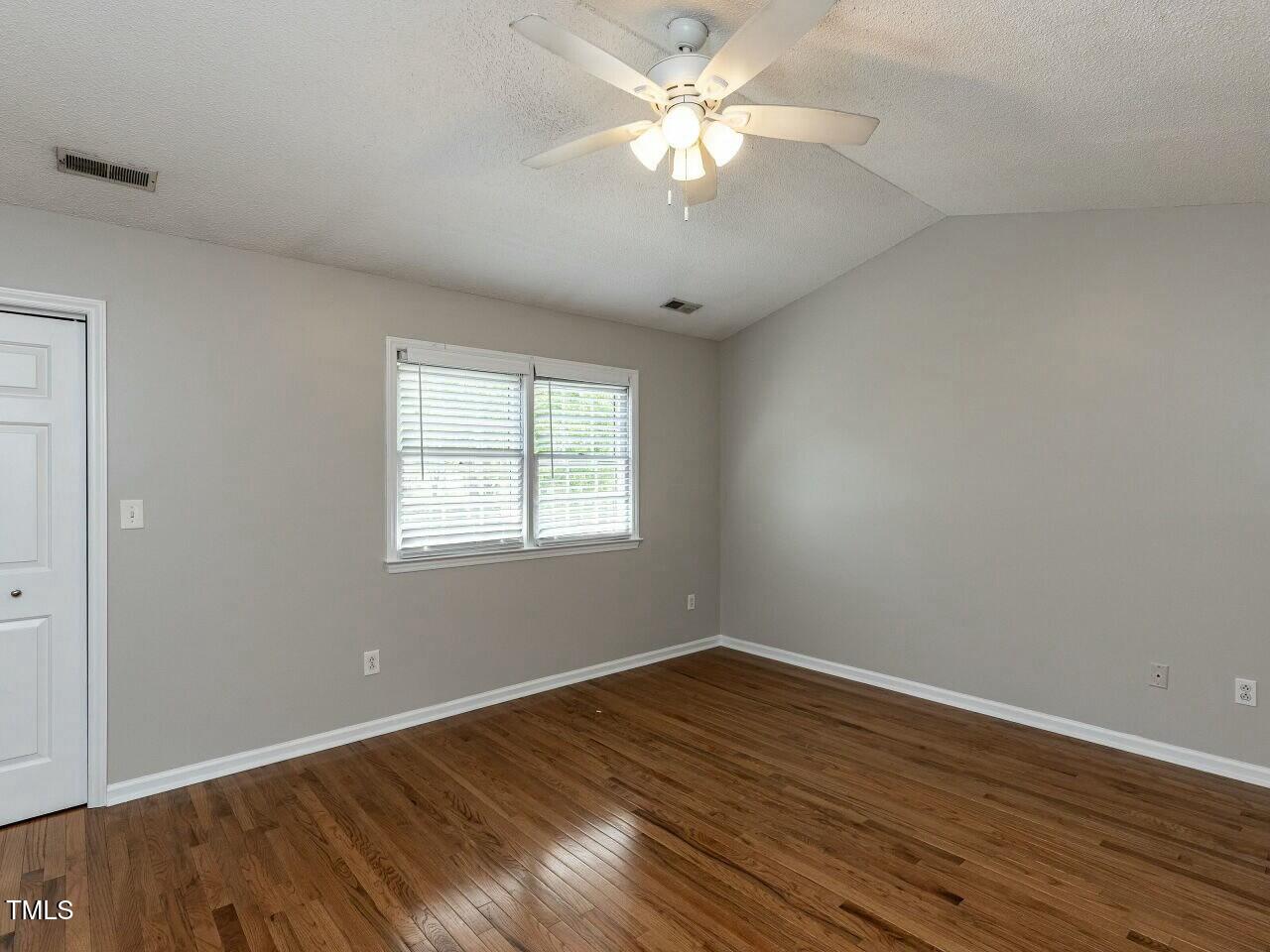 116 Old Maple Lane Durham, NC 27713 - Photo 14 of 30 a view of a room with wooden floor and a ceiling fan