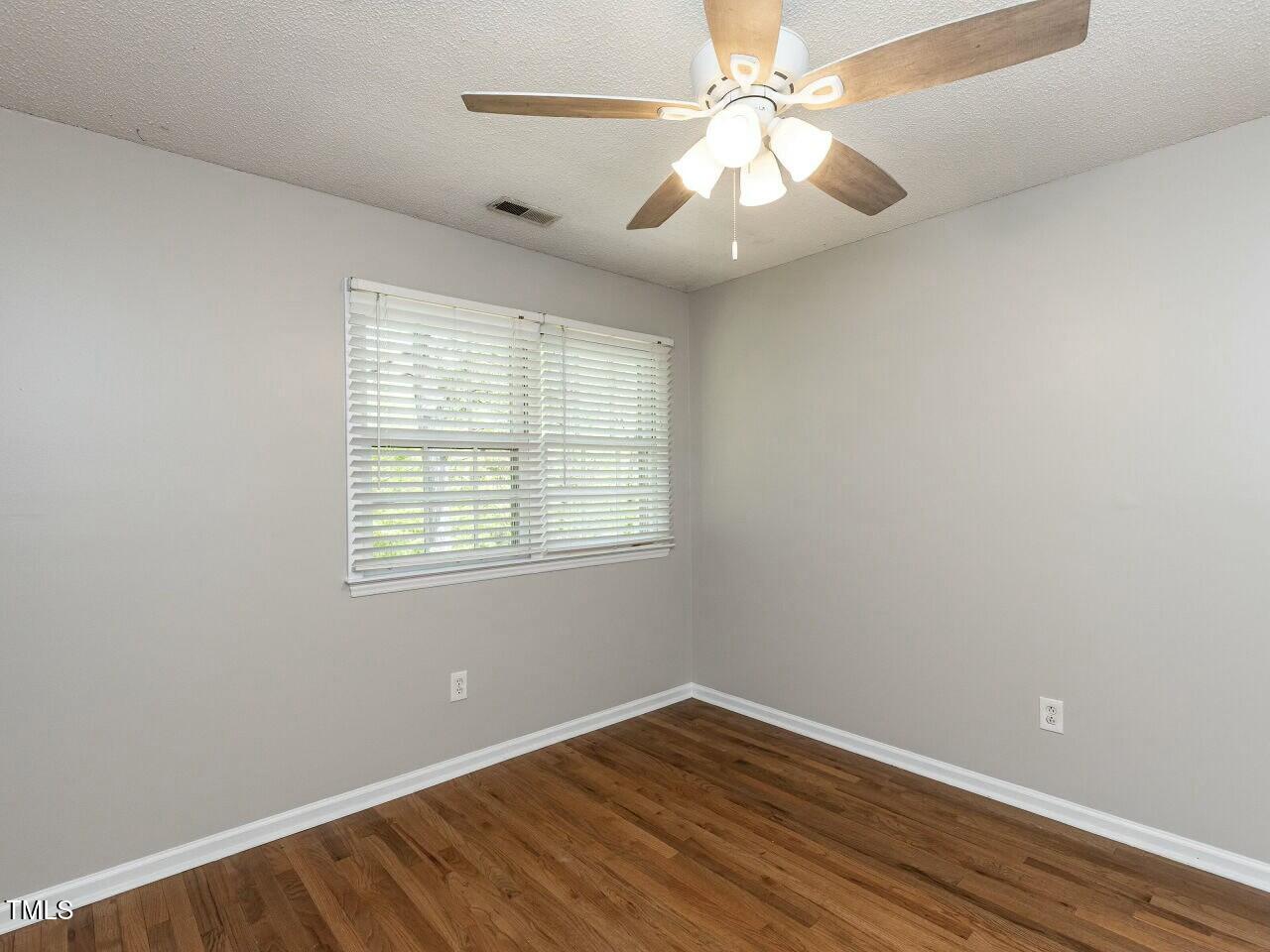 116 Old Maple Lane Durham, NC 27713 - Photo 23 of 30 an empty room with wooden floor and windows