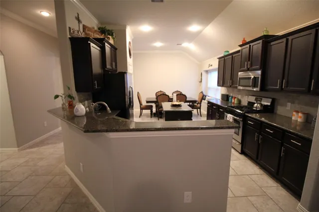 a kitchen with sink a refrigerator and cabinets