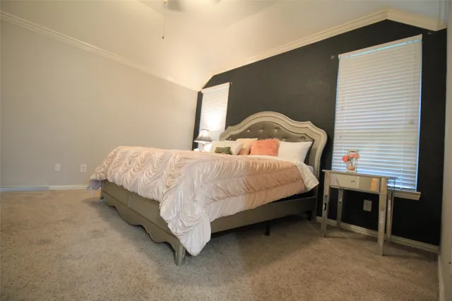 a bedroom with a bed and a dresser