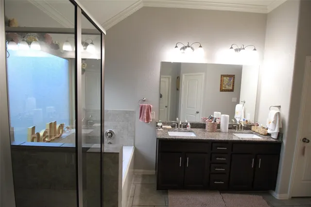 a bathroom with a double vanity sink and a mirror