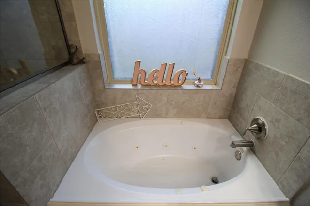 a bath tub sitting in a bathroom next to a sink