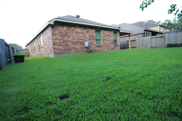 a view of house with yard and entertaining space