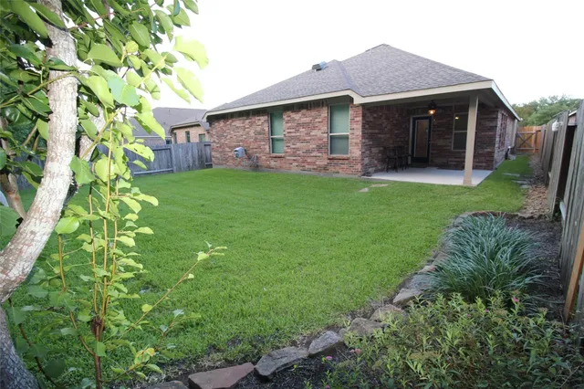 a backyard of a house with table and chairs