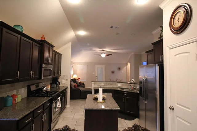 a kitchen with a refrigerator and a sink