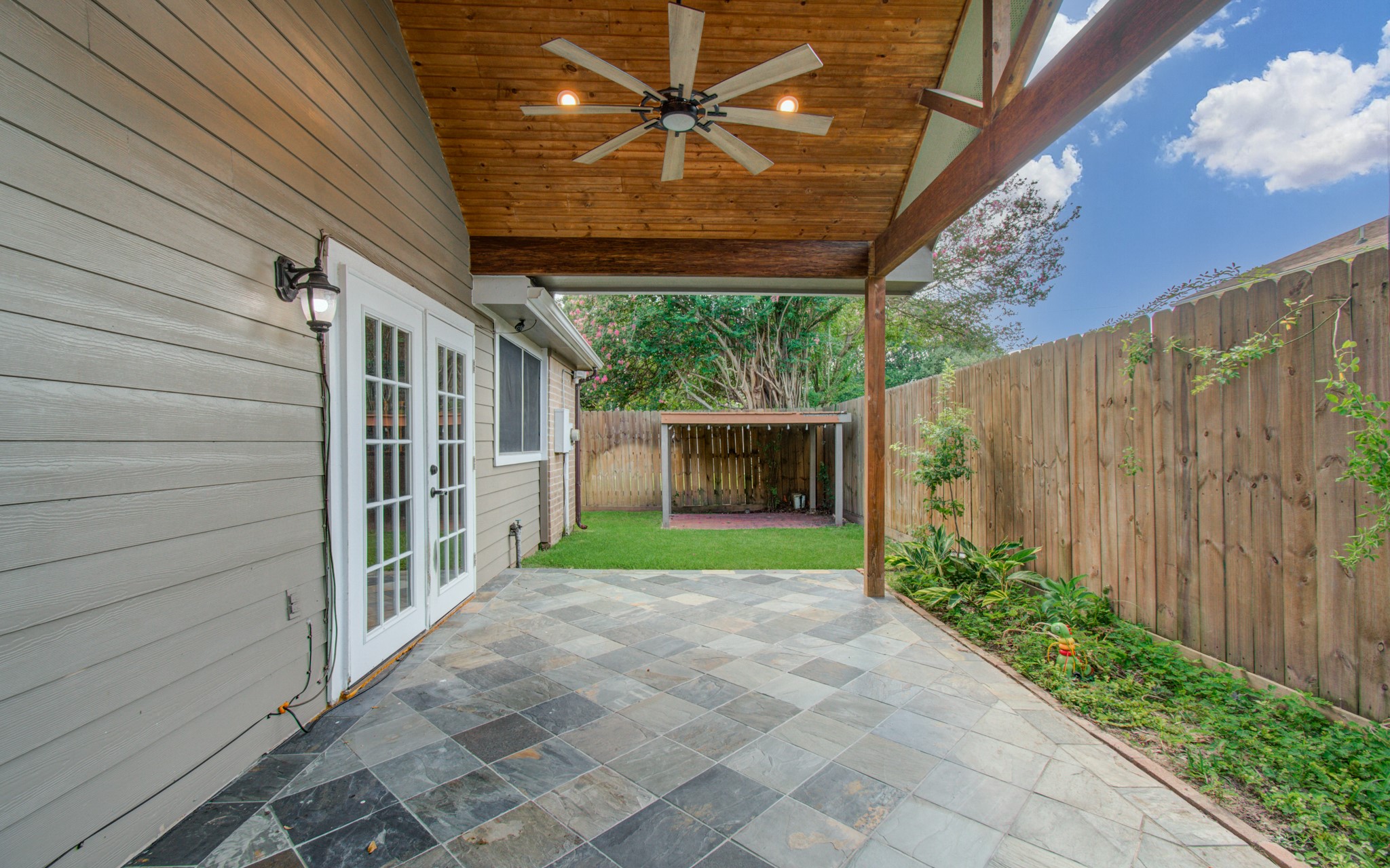 10546 Rippling Fields Drive Houston, TX 77064 - Photo 29 of 31 Look at this gorgeous patio with plank wood ceiling will be perfect for entertaining!