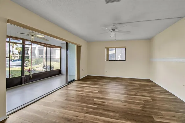 wooden floor in an empty room with a window
