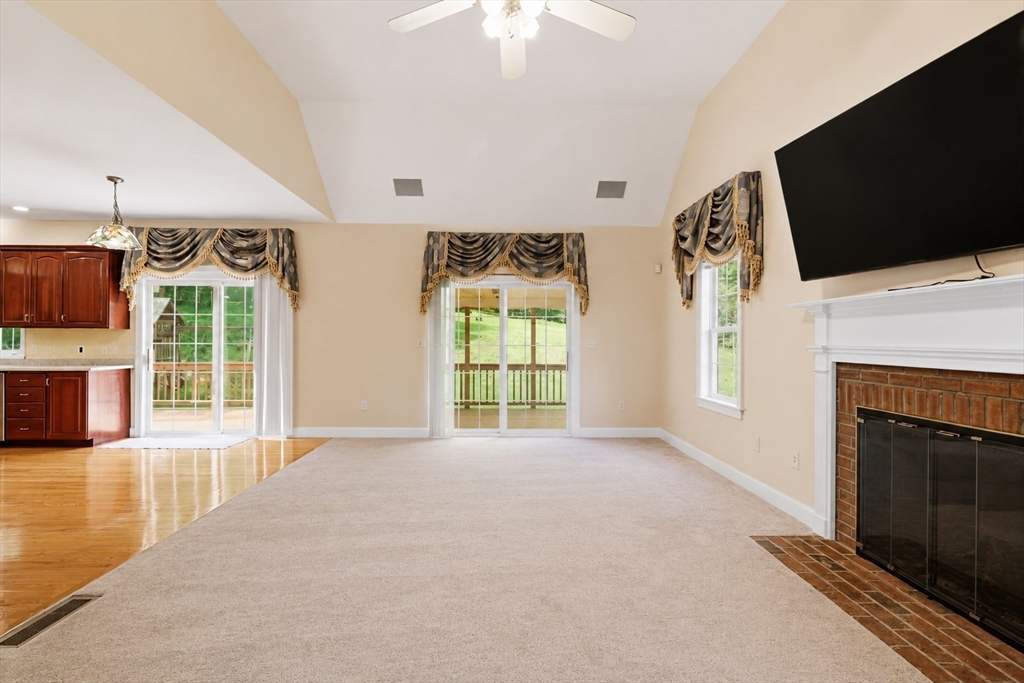 61 Indian Head Road Framingham, MA 01701 - Photo 14 of 42 a view of an empty room with a fireplace and a flat screen tv