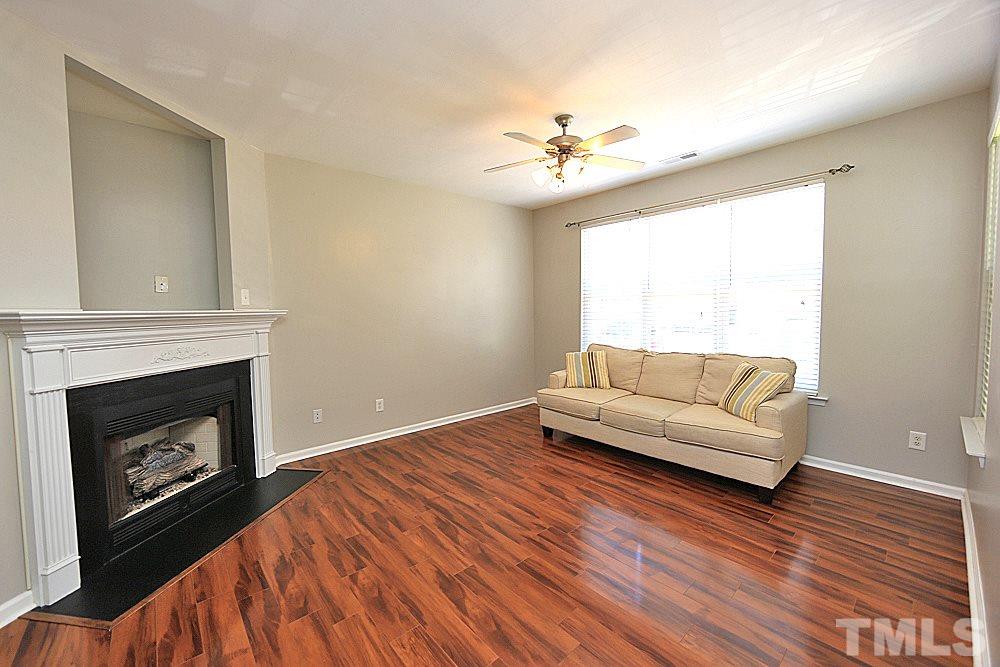 8352 City Loft Court Raleigh, NC 27613 - Photo 3 of 13 a living room with furniture and a fireplace