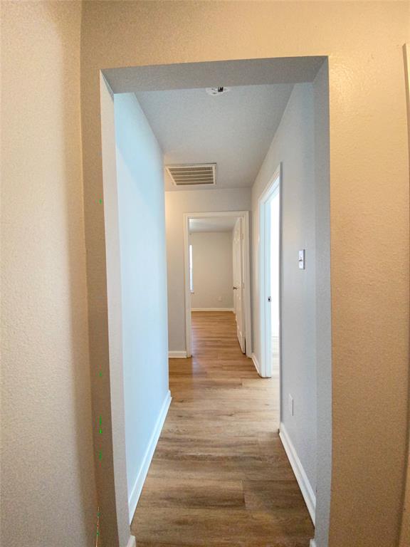6928 Alexandria Court Fort Worth, TX 76133 - Photo 12 of 28 a view of a hallway with wooden floor