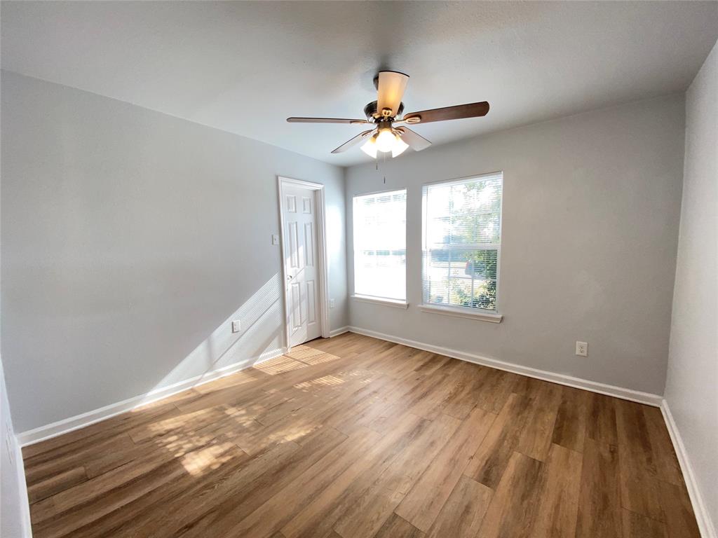 6928 Alexandria Court Fort Worth, TX 76133 - Photo 13 of 28 wooden floor in an empty room with a window