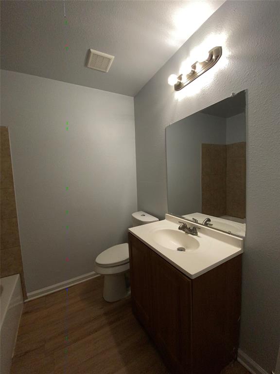 6928 Alexandria Court Fort Worth, TX 76133 - Photo 17 of 28 a bathroom with a sink toilet and mirror