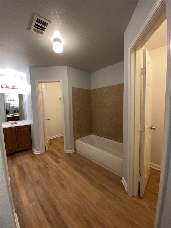 6928 Alexandria Court Fort Worth, TX 76133 - Photo 21 of 28 a bathroom with a bathtub and a shower