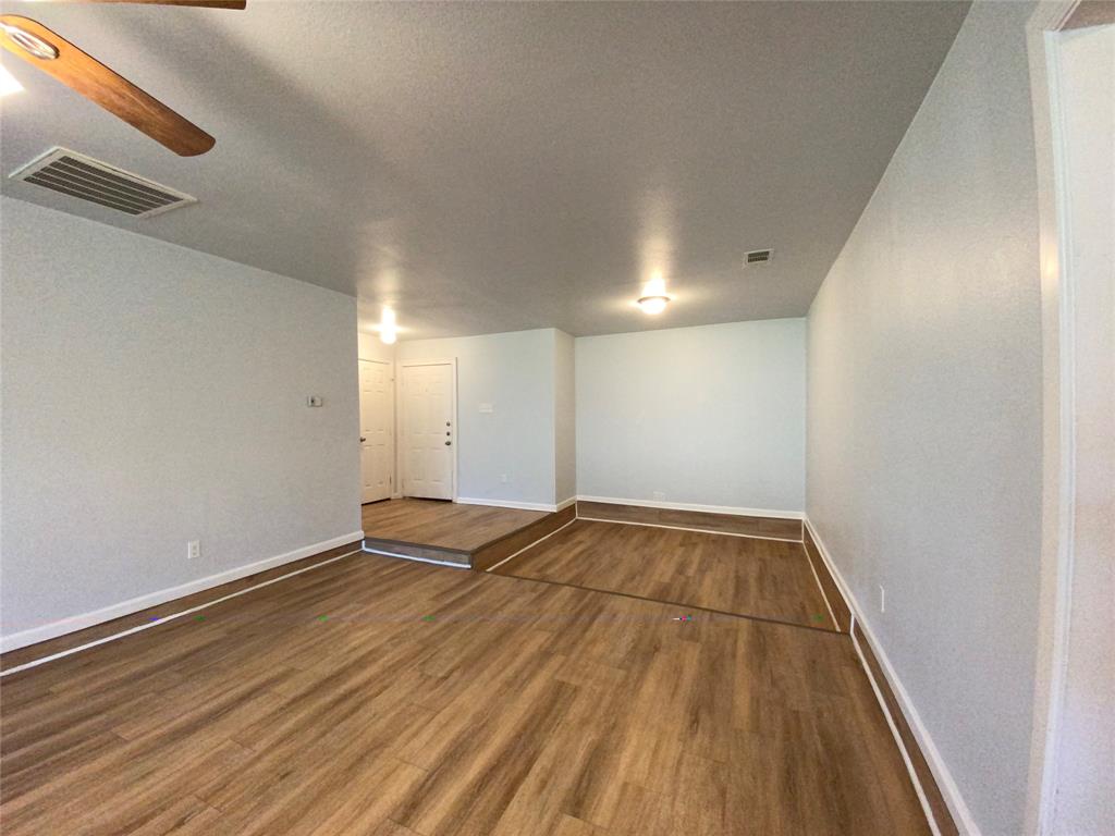 6928 Alexandria Court Fort Worth, TX 76133 - Photo 7 of 28 a view of an empty room with wooden floor