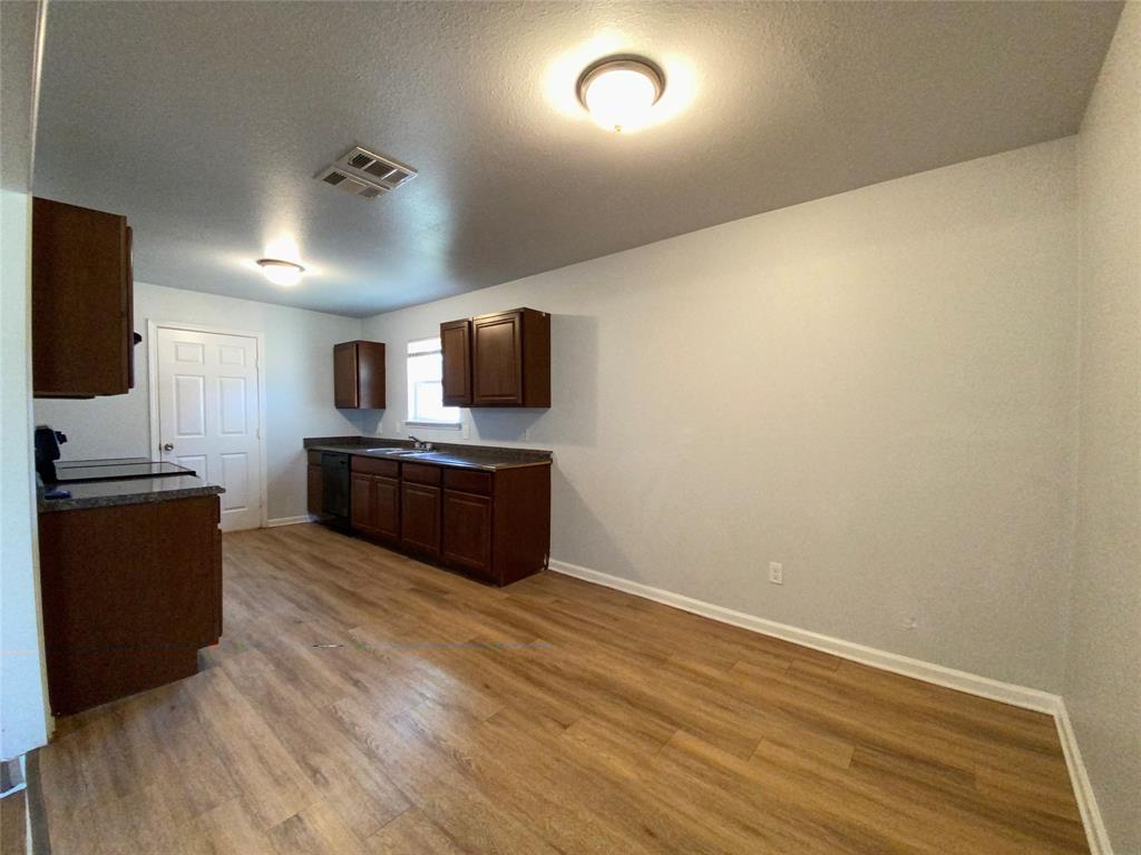 6928 Alexandria Court Fort Worth, TX 76133 - Photo 8 of 28 a large kitchen with a large counter top space a stainless steel appliances and cabinets