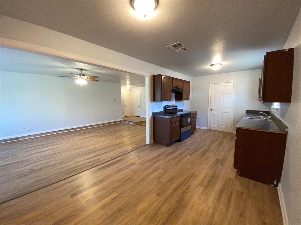 6928 Alexandria Court Fort Worth, TX 76133 - Photo 9 of 28 a living room with furniture and a flat screen tv