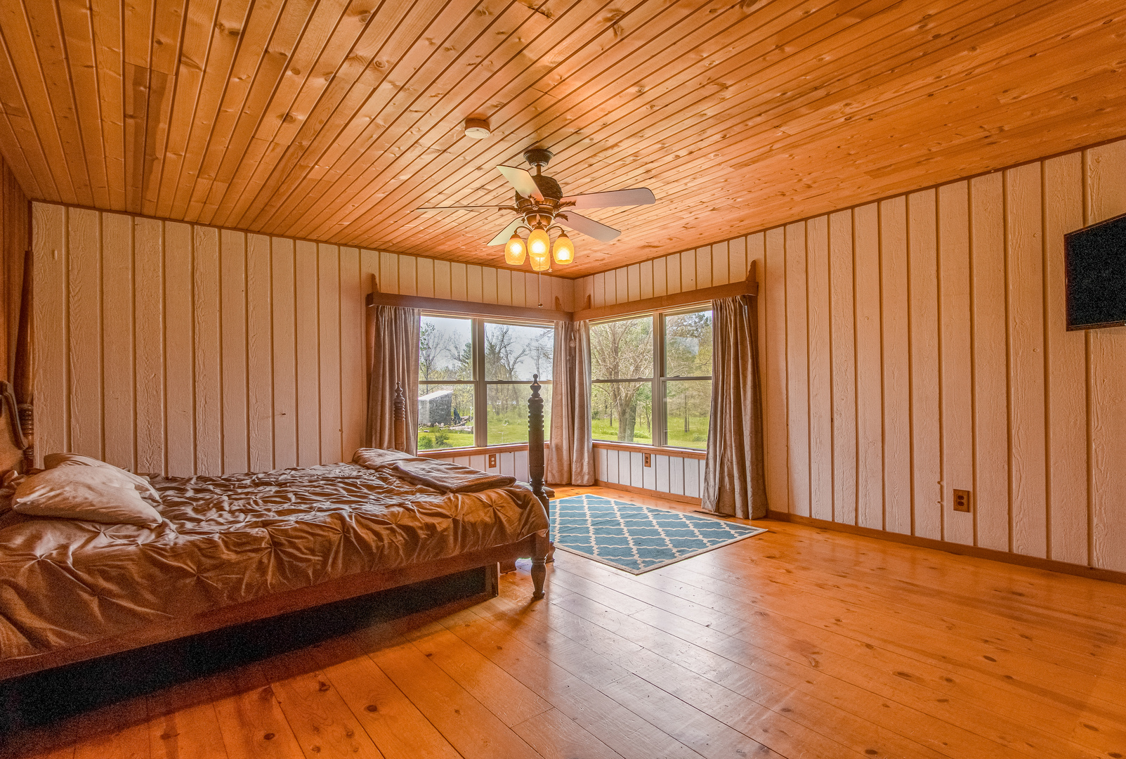 4318 North River Road Byron, IL 61010 - Photo 14 of 28 a spacious bedroom with a bed and a chandelier